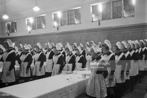 Girls line up for a meal at a London foundling hospital, 3rd May 1941. Picture Post - 444 - Foundling Hospital - pub 1941